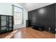 Bright bedroom with hardwood floors, complemented by a large arched window and dark accent wall at 658 Pamlico Ct., Myrtle Beach, SC 29588