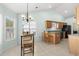 Eat-in kitchen area with a breakfast bar, ample natural light, and stylish chandelier above the dining table at 658 Pamlico Ct., Myrtle Beach, SC 29588