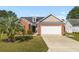 Charming single-Gathering home with brick accents, a well-manicured lawn, and an attached two-car garage at 658 Pamlico Ct., Myrtle Beach, SC 29588