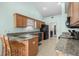 Well-lit kitchen featuring granite countertops, tiled flooring, and modern appliances; perfect for culinary enthusiasts at 658 Pamlico Ct., Myrtle Beach, SC 29588