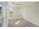 Light-filled bedroom with neutral carpeting and large windows providing natural light at 716 Lapwind Loop, Myrtle Beach, SC 29579