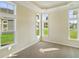 Sunlit bedroom with multiple windows overlooking lush greenery and a tray ceiling at 716 Lapwind Loop, Myrtle Beach, SC 29579