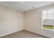 Sunlit bedroom with neutral carpet and walls at 716 Lapwind Loop, Myrtle Beach, SC 29579