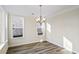 Bright dining area with modern light fixture and views from large windows at 716 Lapwind Loop, Myrtle Beach, SC 29579