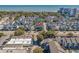 Aerial view of a blue home surrounded by colorful homes near the beach at 7624 Azure Dr., Myrtle Beach, SC 29572