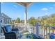 Relaxing balcony with blue chair, small table, and a neighborhood view at 7624 Azure Dr., Myrtle Beach, SC 29572