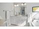 Bright bathroom with double sinks, marble countertops, and white cabinetry at 7624 Azure Dr., Myrtle Beach, SC 29572