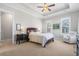 Spacious bedroom with tray ceilings, sitting area, and plenty of natural light from large windows at 7624 Azure Dr., Myrtle Beach, SC 29572