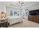 Bright bedroom with tray ceilings, large windows, a ceiling fan, and a private balcony at 7624 Azure Dr., Myrtle Beach, SC 29572