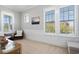 Bright bedroom with three windows offering natural light, neutral carpet and walls at 7624 Azure Dr., Myrtle Beach, SC 29572