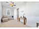 Neutral bedroom with a ceiling fan, pull out couch, console table, and wainscoting at 7624 Azure Dr., Myrtle Beach, SC 29572