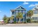 Charming two-story home with a double porch, and beautifully painted blue with a crisp white trim at 7624 Azure Dr., Myrtle Beach, SC 29572