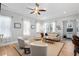 Inviting living room featuring a neutral color palette, comfortable seating, and seamless access to dining area at 7624 Azure Dr., Myrtle Beach, SC 29572