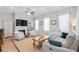 Bright and airy living room with comfortable white seating, a fireplace, and plenty of natural light at 7624 Azure Dr., Myrtle Beach, SC 29572