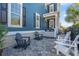 Inviting patio with gray and white chairs in front of a blue, two-story home at 7624 Azure Dr., Myrtle Beach, SC 29572