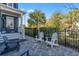 The patio area has four chairs and leads up to a blue home with a covered porch at 7624 Azure Dr., Myrtle Beach, SC 29572