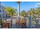 Inviting porch with multiple wood chairs and a bench offering a relaxing outdoor space at 7624 Azure Dr., Myrtle Beach, SC 29572