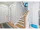 Staircase with wood treads, white risers, and a light-colored wood floor at 7624 Azure Dr., Myrtle Beach, SC 29572