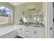 Bright bathroom with a double sink vanity, granite countertop, and a large soaking tub at 802 46Th Ave. S, North Myrtle Beach, SC 29582