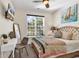 Cozy bedroom with a window view, a quilt on the bed, and a wall-mounted television at 802 46Th Ave. S, North Myrtle Beach, SC 29582