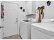 Functional laundry room with white washer and dryer, and storage cabinet at 802 46Th Ave. S, North Myrtle Beach, SC 29582