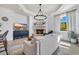 Cozy living room features a fireplace, TV, white sofa, and open view to the dining area at 8068 Cortona Dr., Myrtle Beach, SC 29572