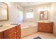 Primary bathroom featuring a soaking tub, double vanity, and natural light at 823 Mount Gilead Place Dr., Murrells Inlet, SC 29576