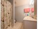 Light bathroom with patterned shower curtain and ample counter space at 823 Mount Gilead Place Dr., Murrells Inlet, SC 29576