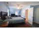 Blue themed bedroom features large windows, and a dark wood king bed at 823 Mount Gilead Place Dr., Murrells Inlet, SC 29576