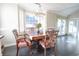 Bright dining area with hardwood floors, dining table with chairs, chandelier and windows at 823 Mount Gilead Place Dr., Murrells Inlet, SC 29576