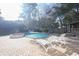 Outdoor pool area with lounge chairs, brick pavers, and mature landscaping at 823 Mount Gilead Place Dr., Murrells Inlet, SC 29576