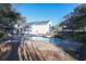 Backyard pool with a waterfall feature and brick pavers surrounded by green foliage at 823 Mount Gilead Place Dr., Murrells Inlet, SC 29576