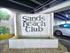 Entrance sign for Sands Beach Club with a water feature and nearby parking at 9400 Shore Dr. # 728, Myrtle Beach, SC 29572