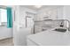 Bright, white kitchen with modern appliances and quartz countertops at 9400 Shore Dr. # 728, Myrtle Beach, SC 29572