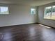 Spacious bedroom features hardwood floors and plentiful natural light from three windows at 1001 Cavaletti Ct., Myrtle Beach, SC 29588