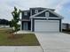 Charming two-story home with blue siding, white trim, and a large two car garage at 1001 Cavaletti Ct., Myrtle Beach, SC 29588