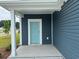 Close-up of the home's entry with a light blue front door and white trim at 1001 Cavaletti Ct., Myrtle Beach, SC 29588