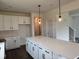 Open kitchen featuring a large island with white countertops and pendant lighting at 1001 Cavaletti Ct., Myrtle Beach, SC 29588