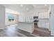 Well-lit kitchen with white cabinets, stainless steel appliances, and a granite-topped island at 1245 Cypress Shoal Dr., Conway, SC 29526
