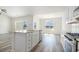 Kitchen island with white cabinets and granite countertop, alongside stainless steel appliances and wood-style flooring at 1245 Cypress Shoal Dr., Conway, SC 29526