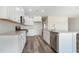 Modern kitchen featuring white cabinetry, stainless steel appliances, and stylish wood floors at 1245 Cypress Shoal Dr., Conway, SC 29526