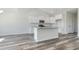 Kitchen featuring white cabinetry, granite counters, stainless steel appliances, and wood flooring at 1245 Cypress Shoal Dr., Conway, SC 29526