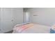Simple bedroom has a bed with a striped blanket on it, with a white door on the left side of the frame at 128 Shucking St., Myrtle Beach, SC 29588