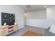 Bright bonus room features neutral walls, a games console, and an ottoman for relaxing or entertaining guests at 128 Shucking St., Myrtle Beach, SC 29588