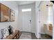 Inviting entryway featuring a stylish wooden bench with decorative pillows and a patterned rug for added appeal at 128 Shucking St., Myrtle Beach, SC 29588
