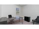 Neutral office space with a large gray desk, two chairs, a window, and a filing cabinet; perfect for productivity at 128 Shucking St., Myrtle Beach, SC 29588