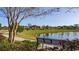 Beautiful community pond with a sidewalk, gazebo, bench, landscaping, and a clear blue sky at 128 Shucking St., Myrtle Beach, SC 29588