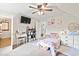 Cozy bedroom features a ceiling fan, white trim, and a small vanity area at 1303 Elizabeth St., North Myrtle Beach, SC 29582