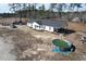 Aerial view of home with pool, trampoline, and large yard surrounded by trees at 160 Leadwood St., Andrews, SC 29510