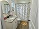 Charming bathroom with granite vanity, polka dot shower curtain, and decorative floor mat at 160 Leadwood St., Andrews, SC 29510
